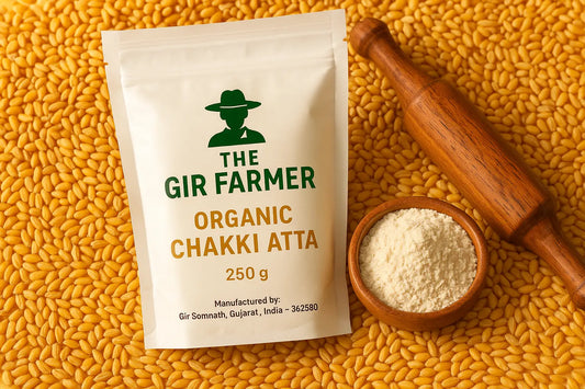 The Gir Farmer Organic Whole Wheat Flour in a 250g bag with raw wheat grains and a rolling pin