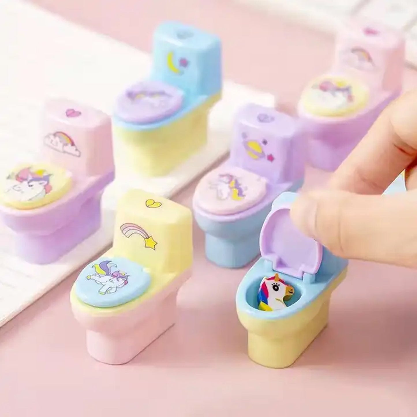 Colorful toilet shaped pencil sharpener with eraser featuring unicorn designs for fun stationery