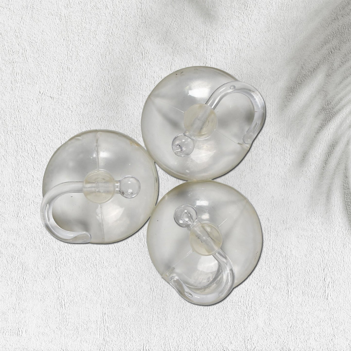 Set of three transparent rubber vacuum hangers for secure hanging solutions in home improvement projects