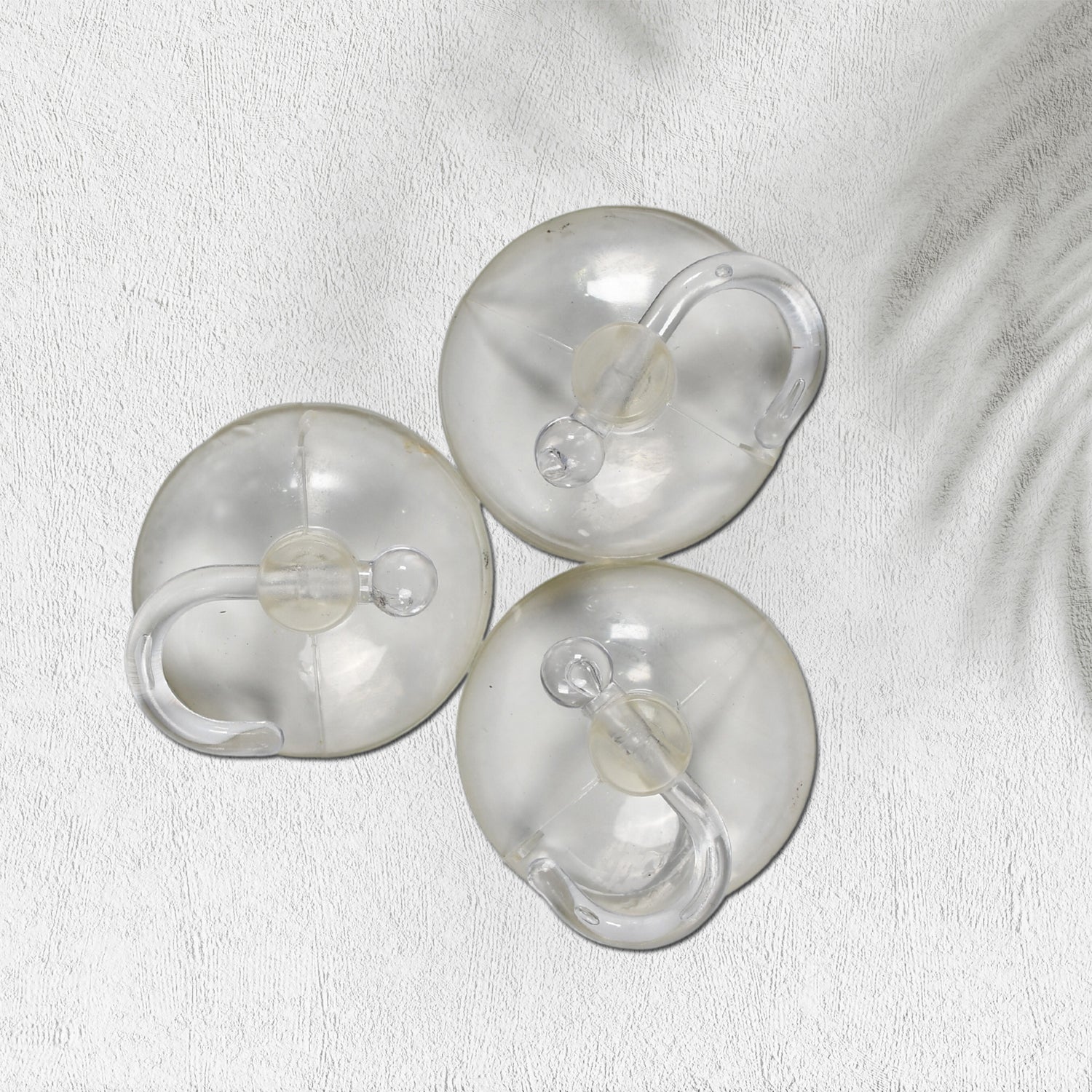 Set of three transparent rubber vacuum hangers for secure hanging solutions in home improvement projects