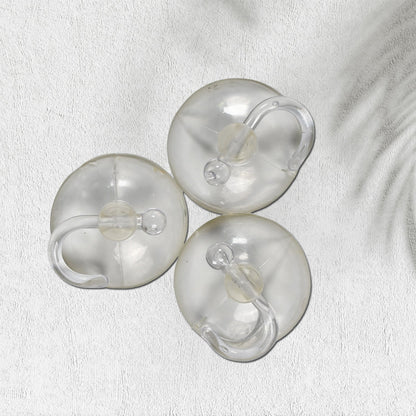 Set of three transparent rubber vacuum hangers for secure hanging solutions in home improvement projects