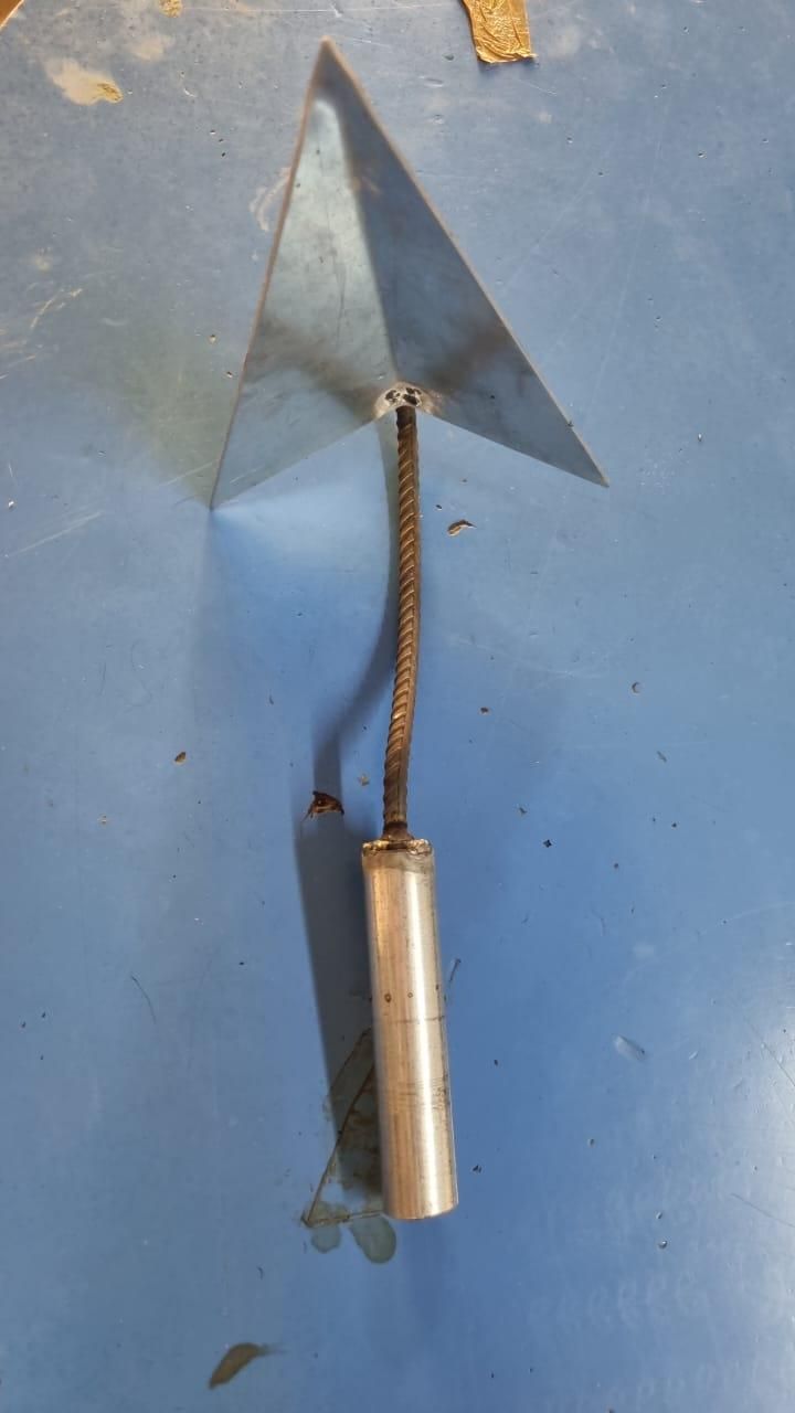 Triangle weed remover tool with metal triangular blade and metal handle on blue surface