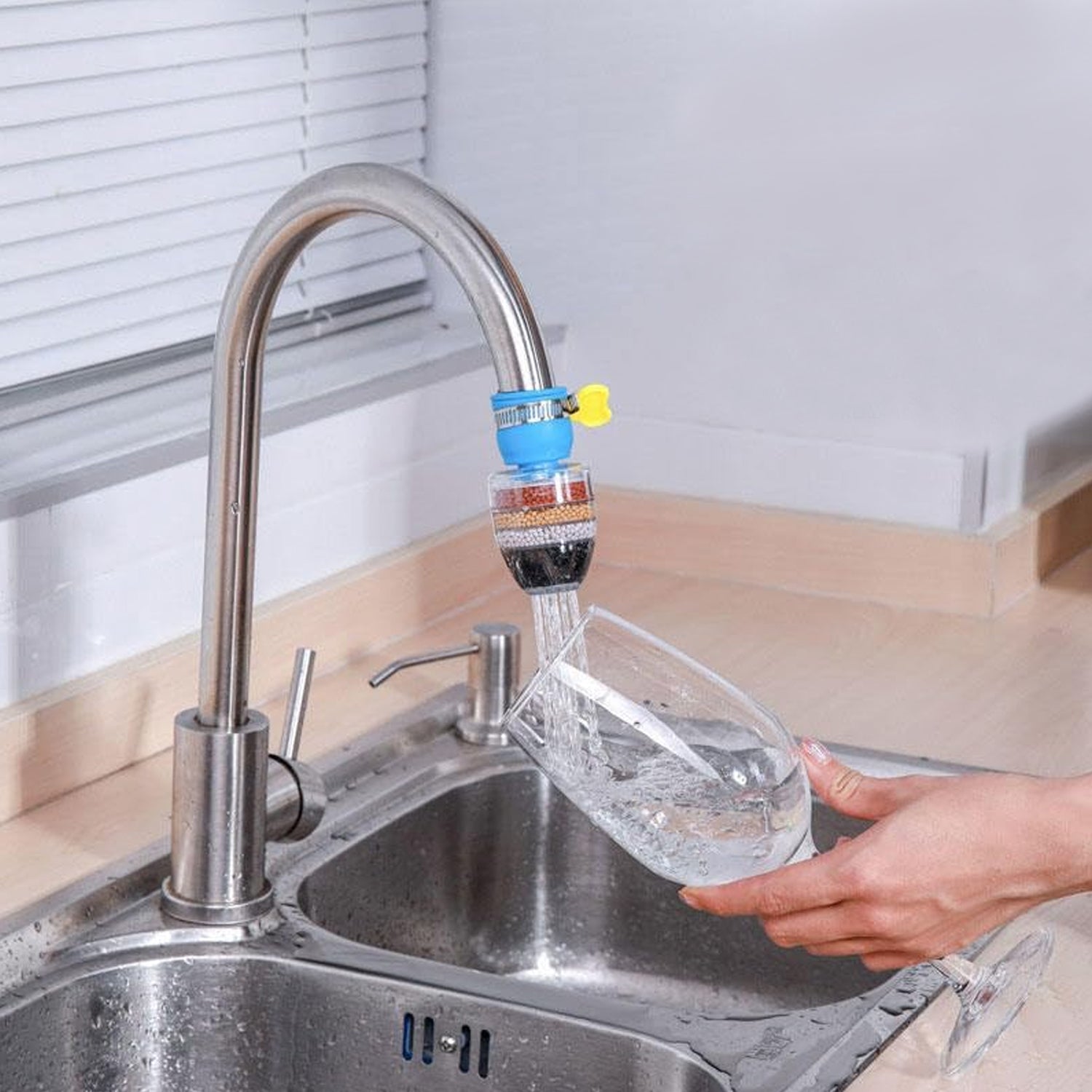 Universal faucet water filter attachment providing clean water directly into a glass from the kitchen faucet