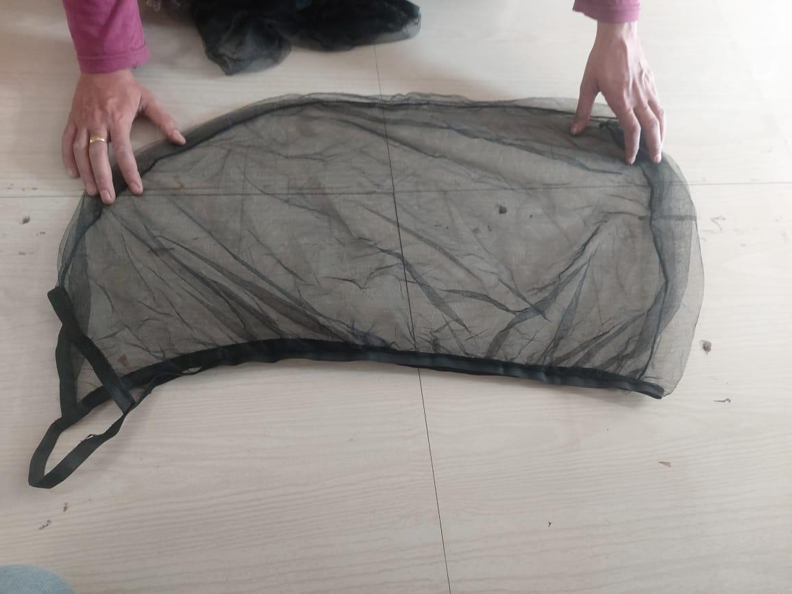 UV protection mesh curtain being laid out on a floor for installation or display
