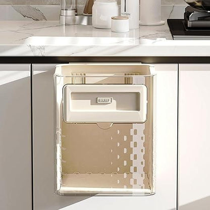 The Gir Farmer foldable wall mounted trash can attached to white kitchen cabinet under countertop