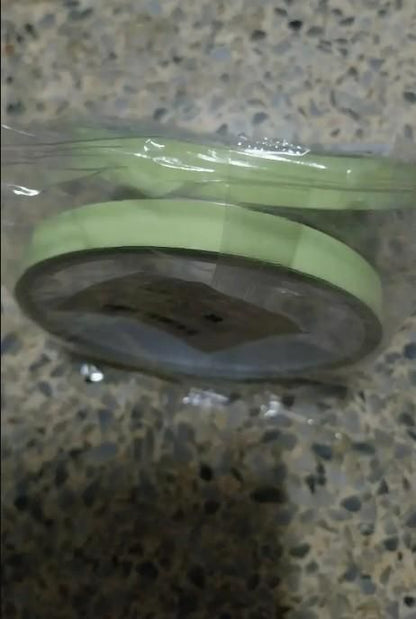 The Gir Farmer glow in the dark safety tape roll wrapped in clear plastic on a textured surface