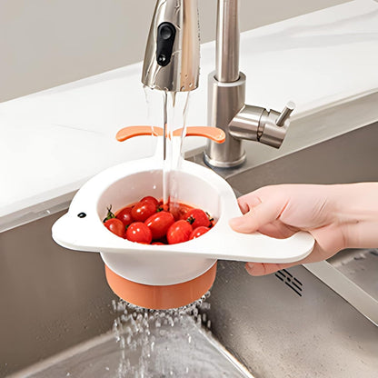 White whale drain basket for kitchen washing cherry tomatoes under running faucet with hand holding it