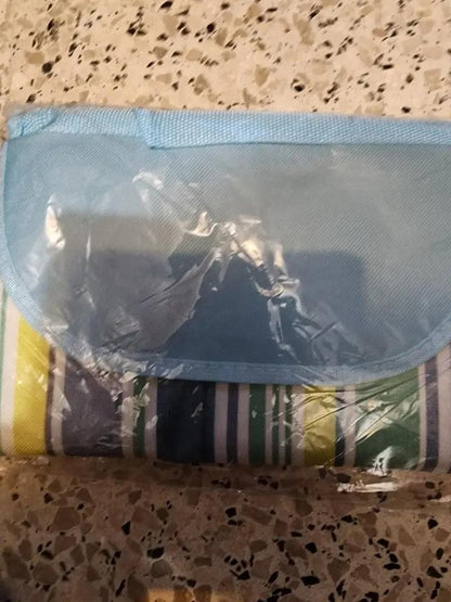 Folded washable picnic mat with colorful stripes, perfect for outdoor gatherings