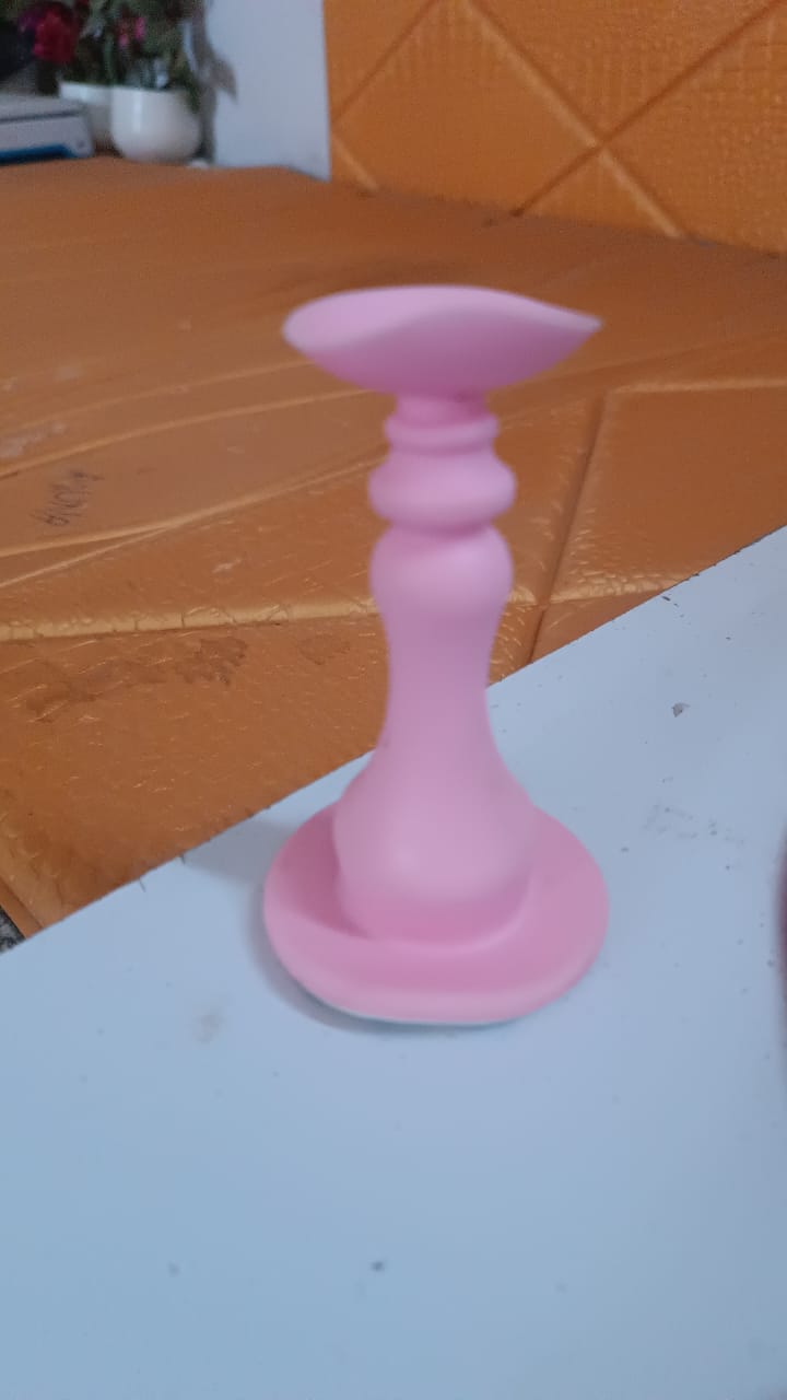 Pink washing machine door holder designed to keep appliance doors open for convenience