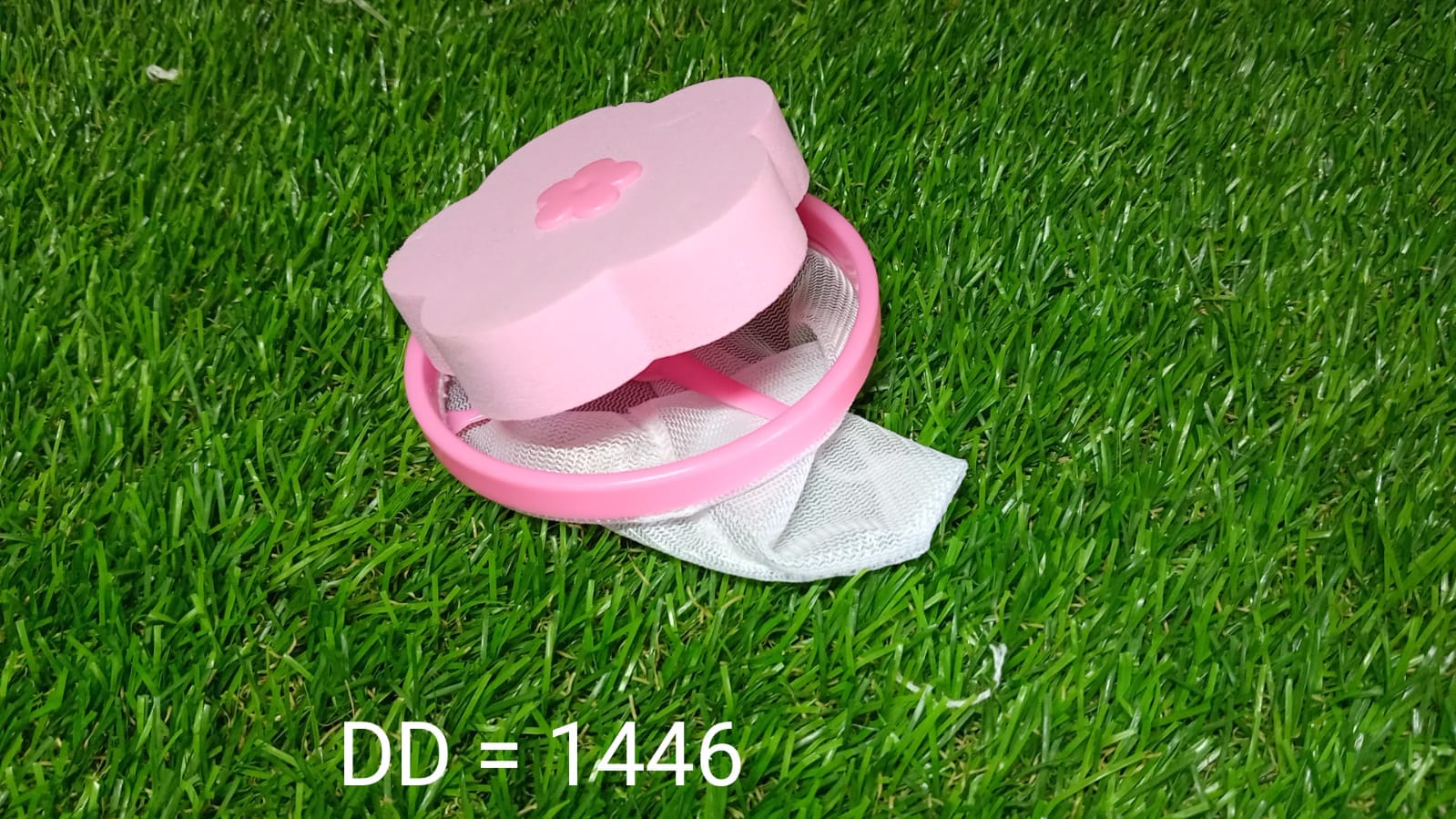 Washing machine lint catcher in pink with a mesh net for effective lint removal
