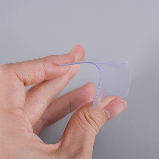 Hand holding clear waterproof nano adhesive tape designed for strong, versatile bonding in various applications