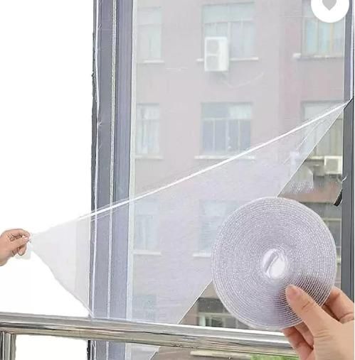 THE GIR FARMER window mosquito netting being applied to a window frame with adhesive tape roll