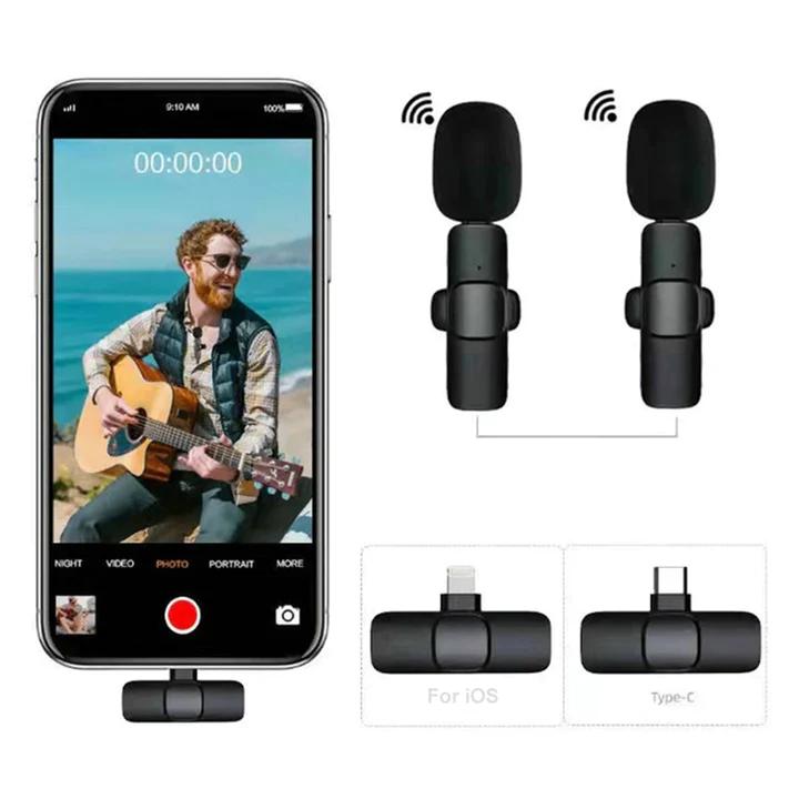Two black wireless lavalier microphones for recording connected to a smartphone with video recording feature