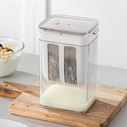 Compact yogurt maker with strainer for homemade Greek yogurt placed on wooden board
