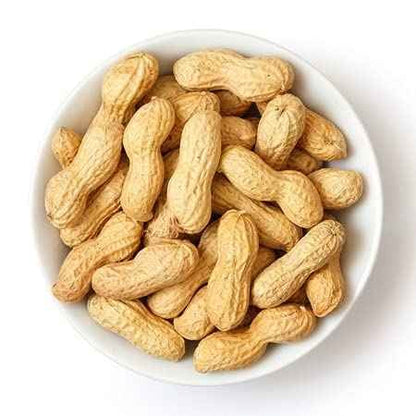 Bowl of brown organic groundnuts with shell, perfect for snacking or baking recipes